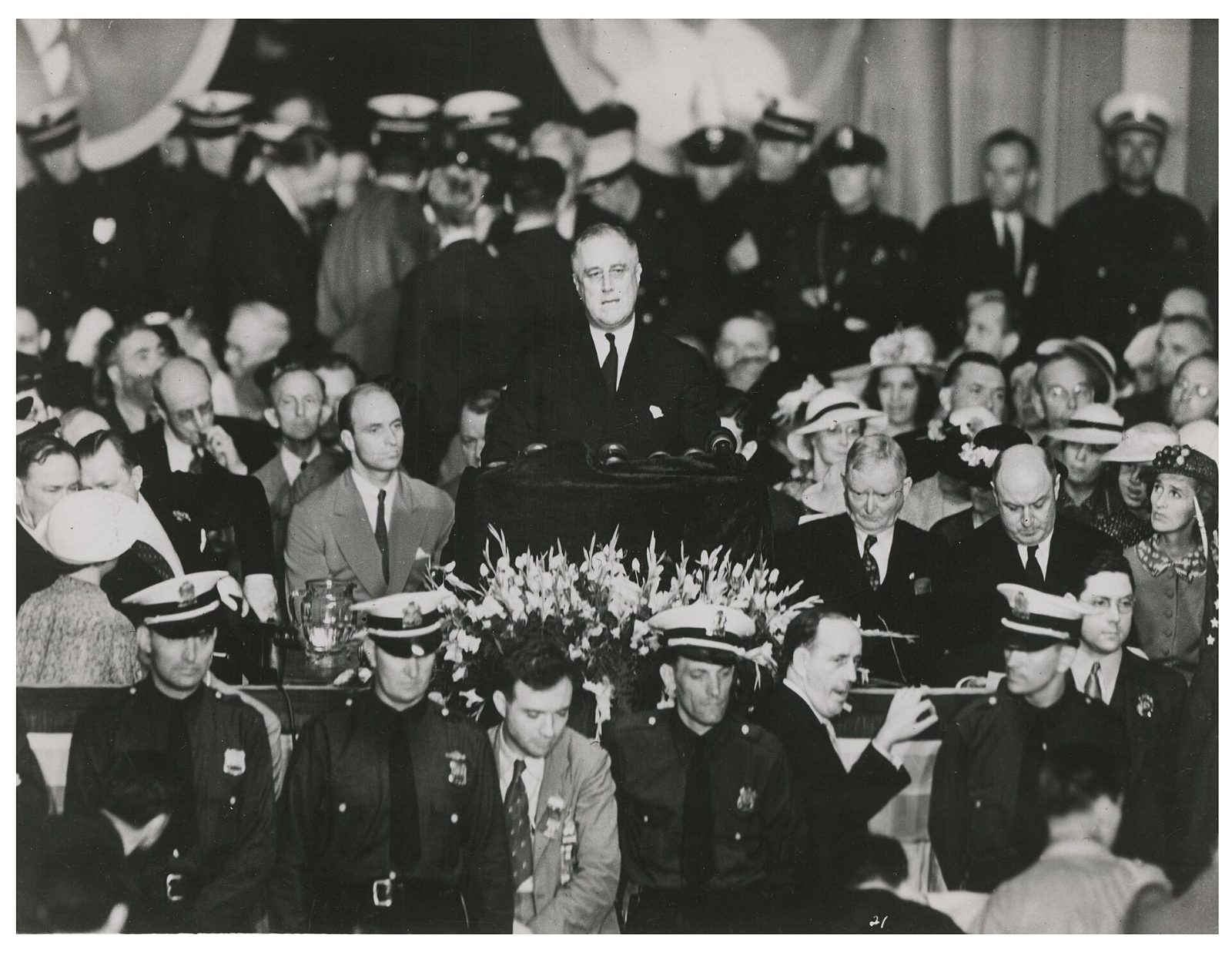 Franklin Roosevelt speaking at a podium before a crowd in 1936
